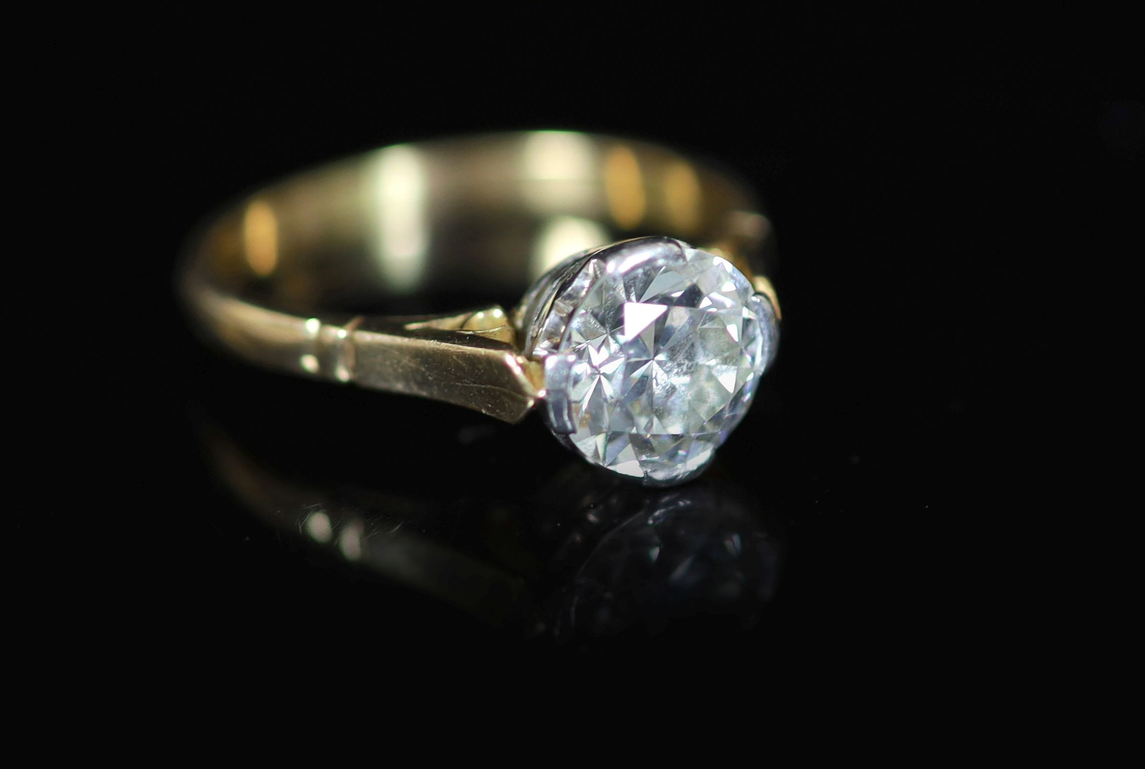 A gold and solitaire diamond ring